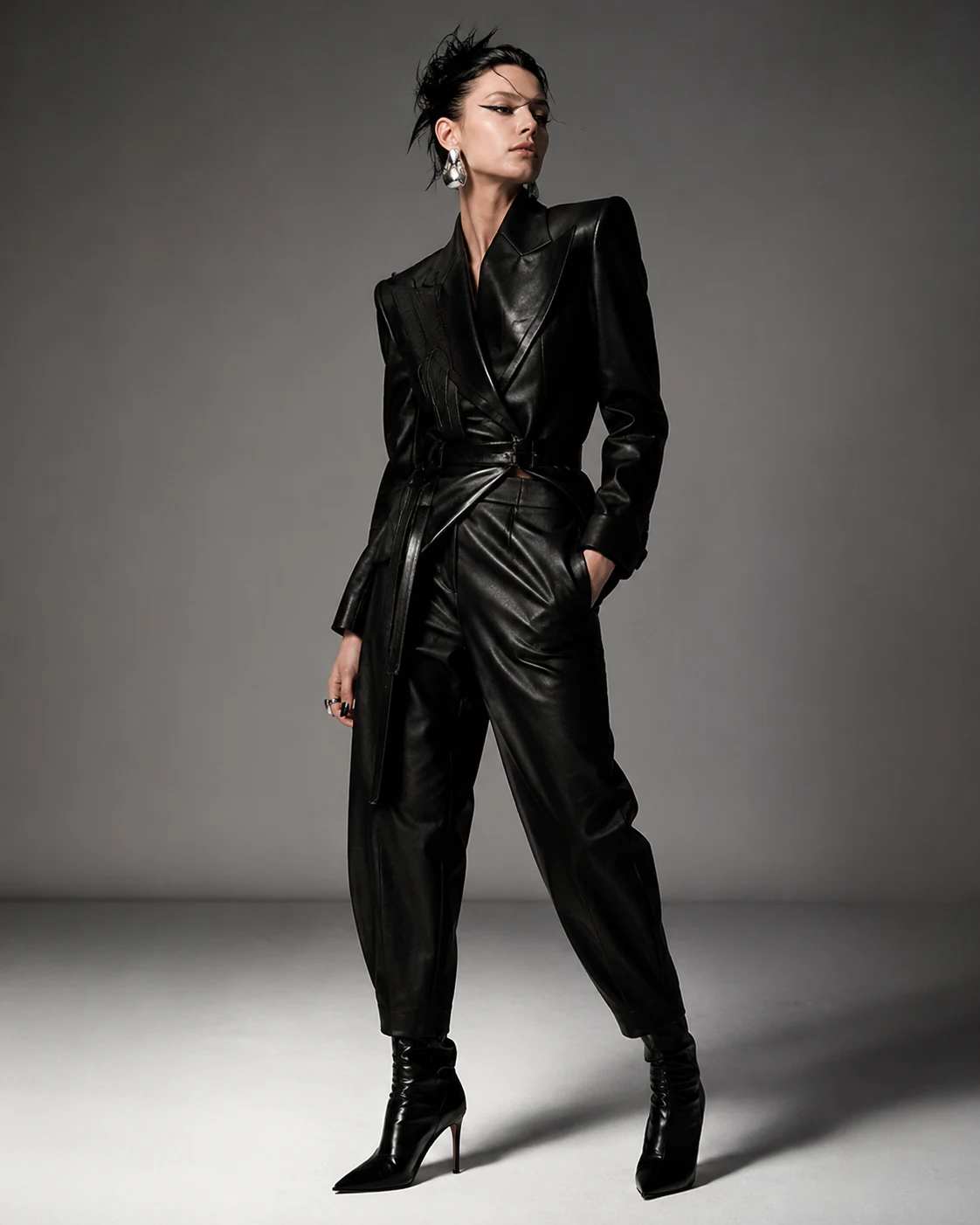 Edgy style archetype: woman in black leather suit and heeled boots, slicked hair
